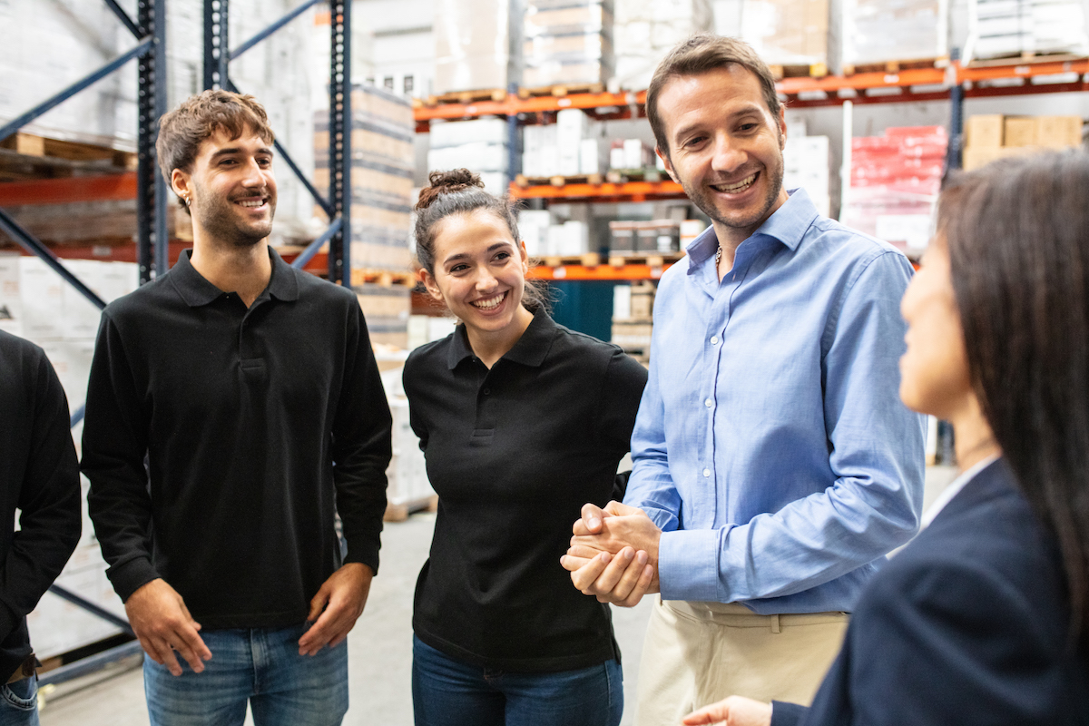 Warehouse foreman having a meeting with workers